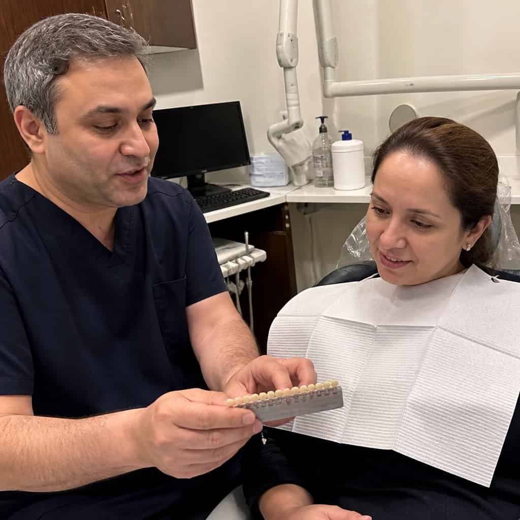 A dentist discussing dental bonding options with a patient in Norwalk, CT