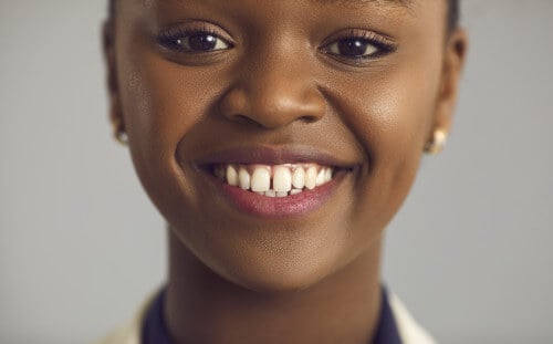Tooth replacement options at The Harmony Dental Group featuring dental implants, bridges, and partial dentures.