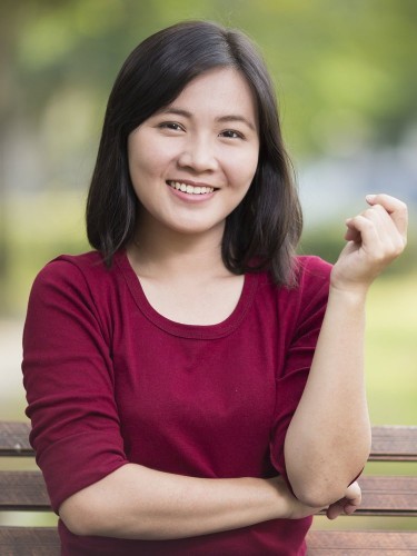 Woman smiling big outdoors demonstrating mouth comfort