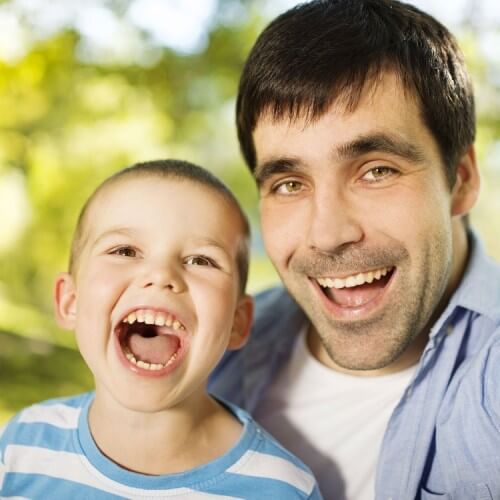 Father and son in nature taking selfie with open mouths